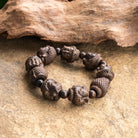 Buddha Wood Bracelet with serene Buddha face wood beads, 18mm size, on flexible elastic cord.