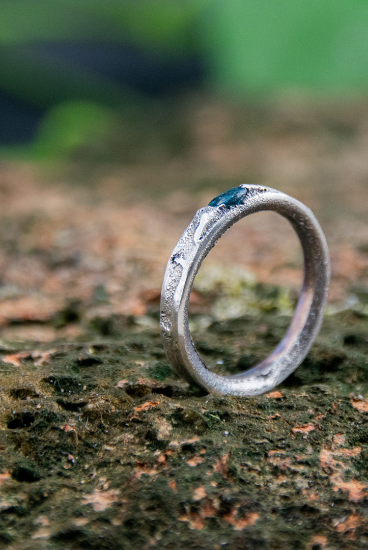 Blue Sky zirconia sand casting ring showcasing unique textures and organic shapes on a natural background.