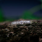 Crystal zirconia sandcasting ring showcasing unique organic textures and artisanal craftsmanship in a natural setting.