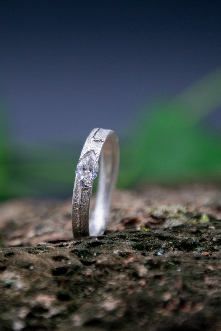 Elegant crystal zirconia sand casting ring showcasing unique textures and craftsmanship on a natural backdrop.