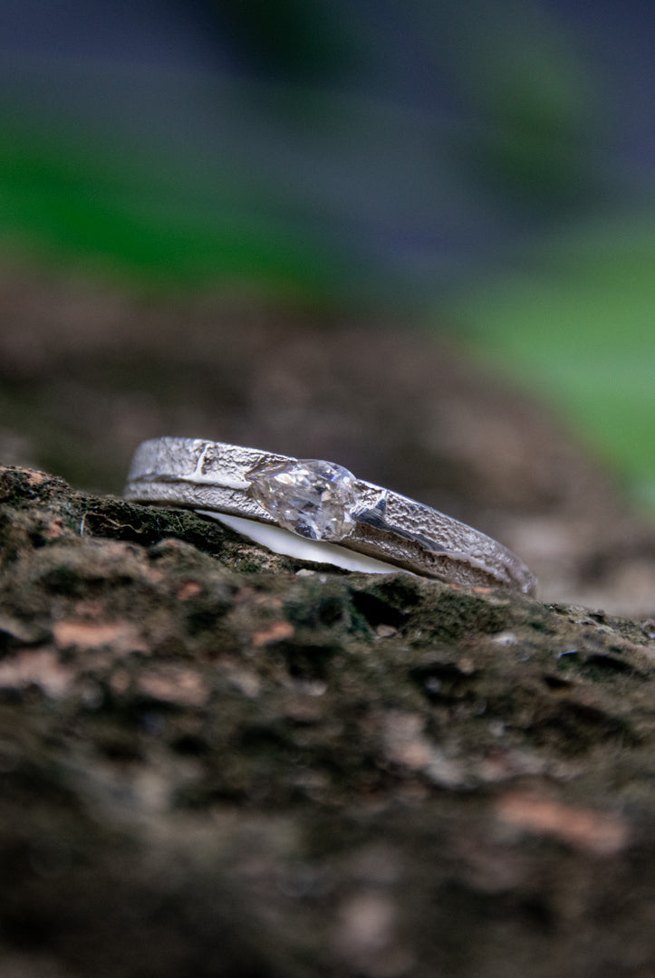 Unique crystal zirconia sand casting ring showcasing organic textures and artisanal craftsmanship against a natural backdrop.