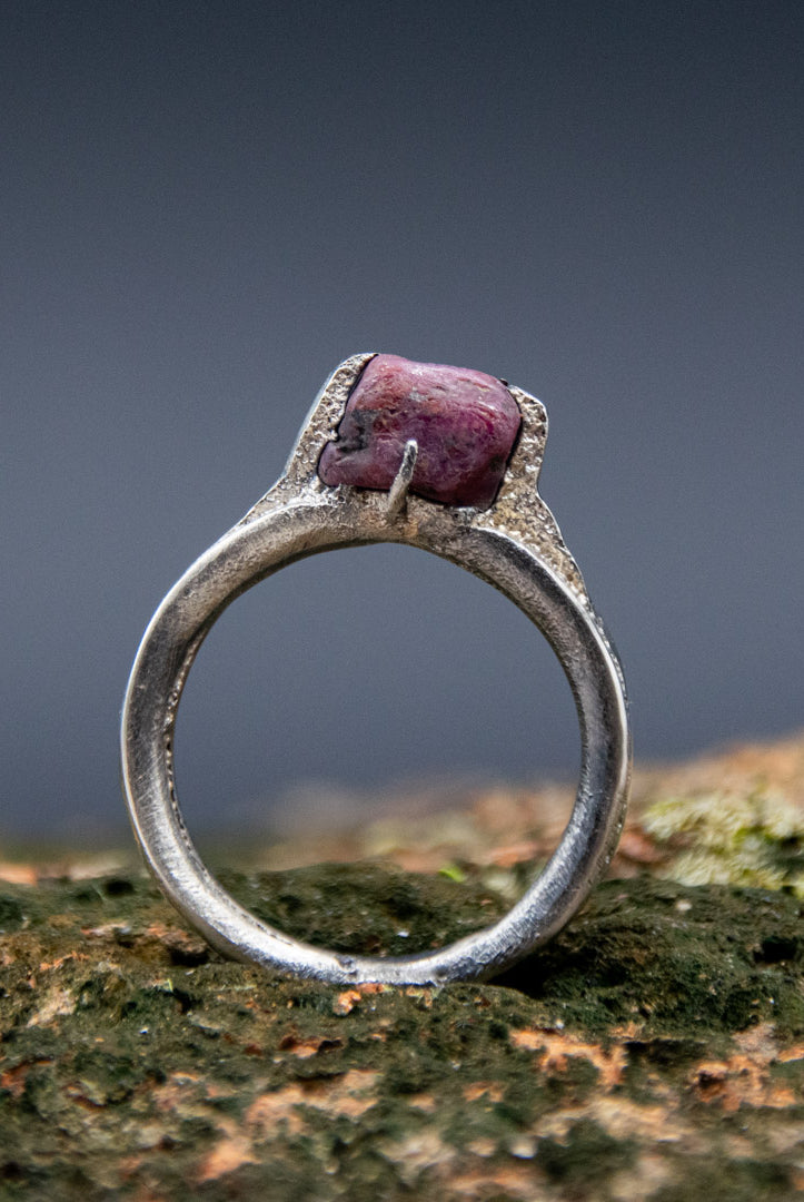 Handcrafted sand casting ring featuring a unique raw ruby stone, showcasing artisanal craftsmanship and organic textures.