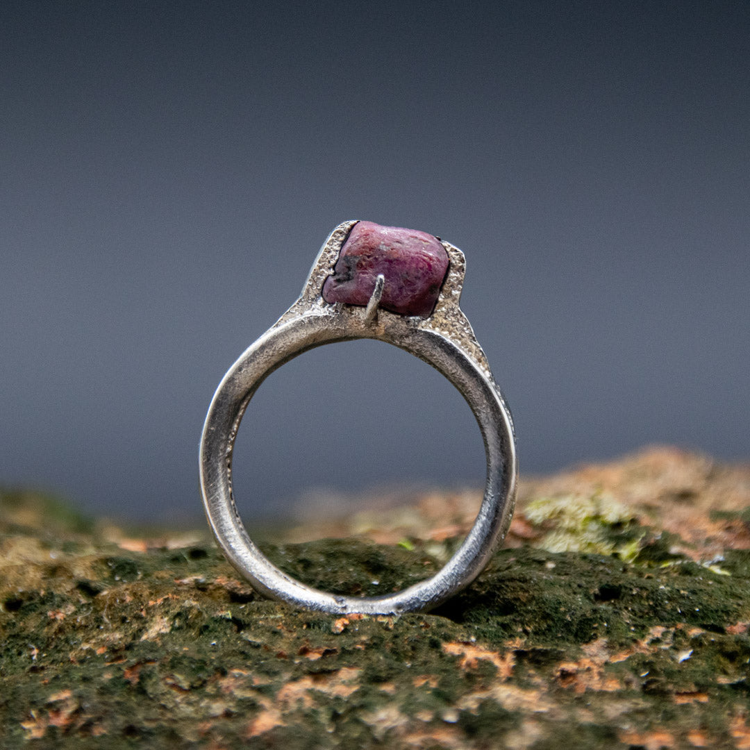 Handcrafted sand casting ring featuring a unique raw ruby stone, showcasing artisanal craftsmanship and organic textures.