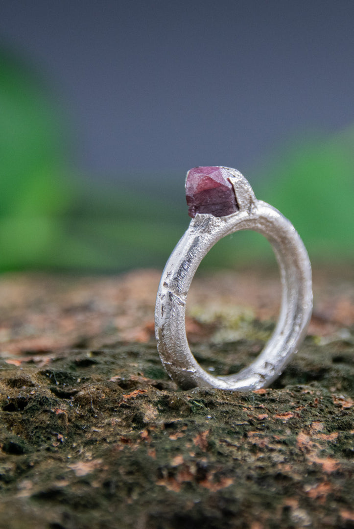 Unique raw ruby round ring with organic texture, crafted using sand casting technique.