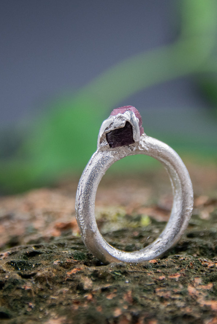 Stunning raw ruby round ring crafted through sand casting, showcasing unique textures and organic shapes.