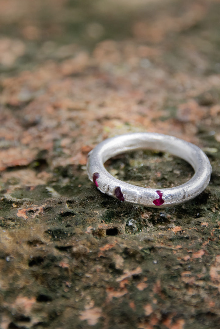 Three Little Ruby round ring crafted using sandcasting technique, showcasing unique textures and organic shapes.