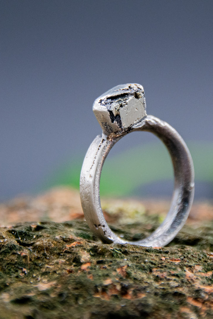 Handcrafted pyrite gemstone ring in a unique sandcast design showcasing organic textures.