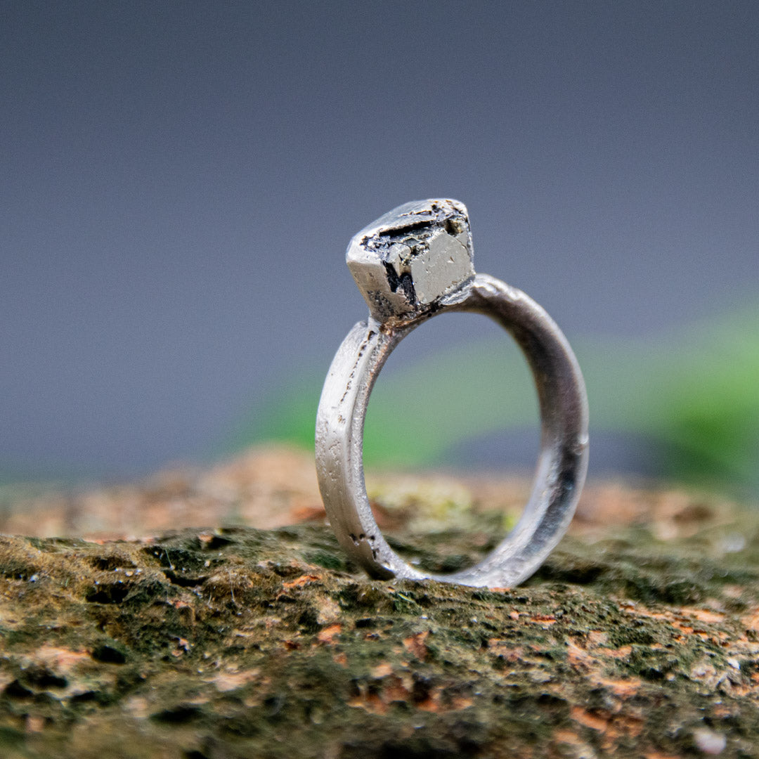 Handcrafted pyrite gemstone ring in a unique sandcast design showcasing organic textures.