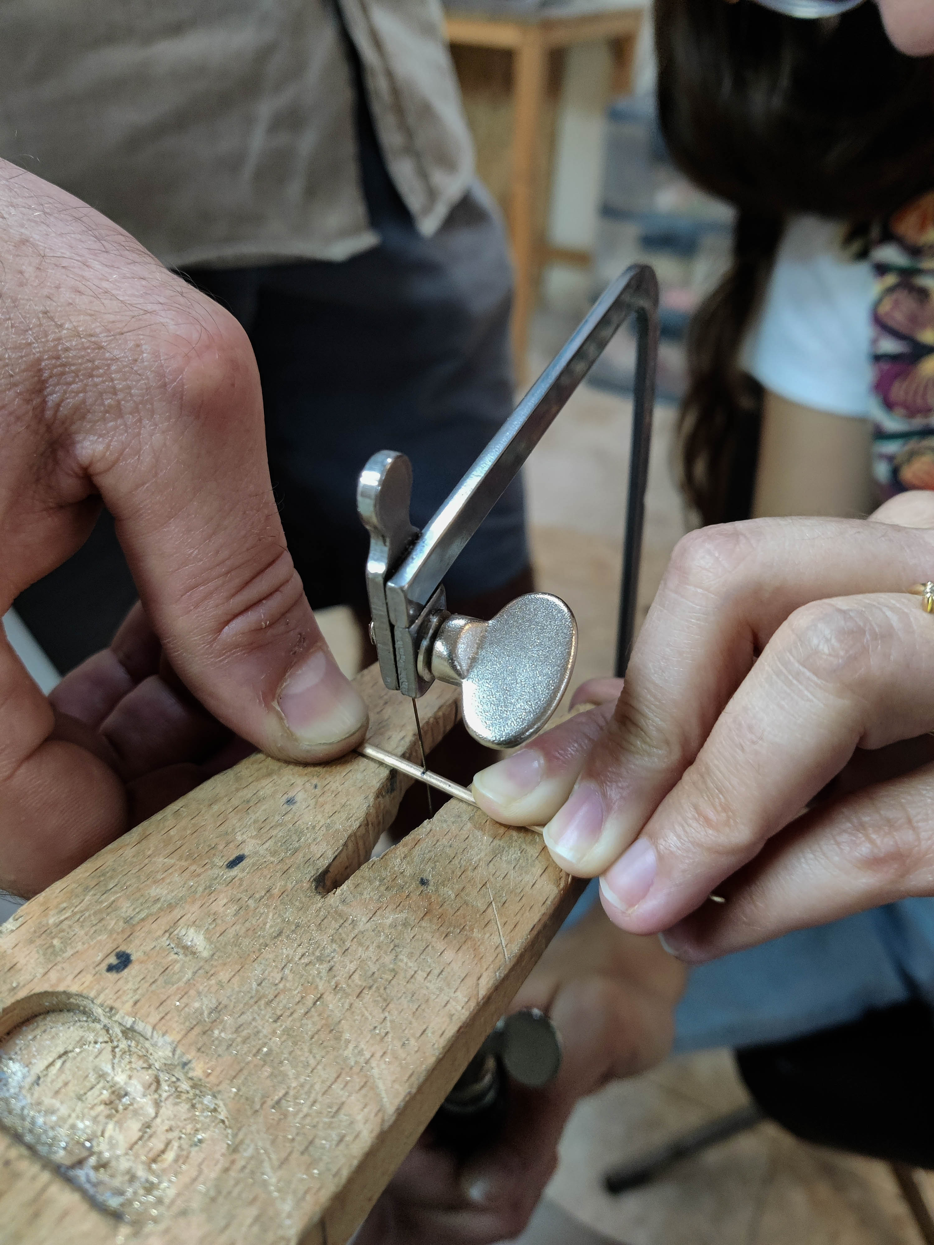 Sawing gold band during wedding ring making workshop in Koh Chang Thailand.