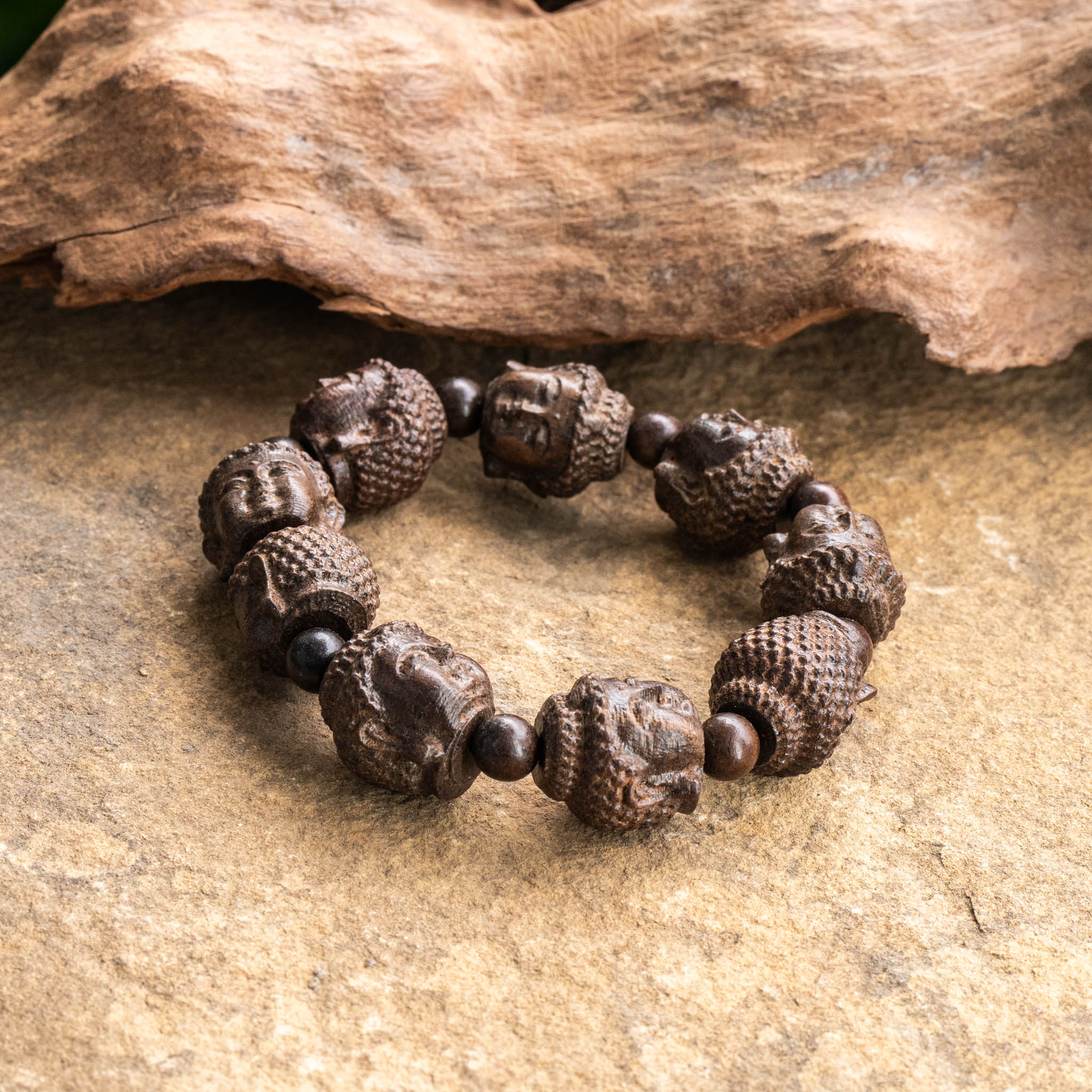 Buddha Wood Bracelet with serene Buddha face wood beads, 18mm size, on flexible elastic cord.
