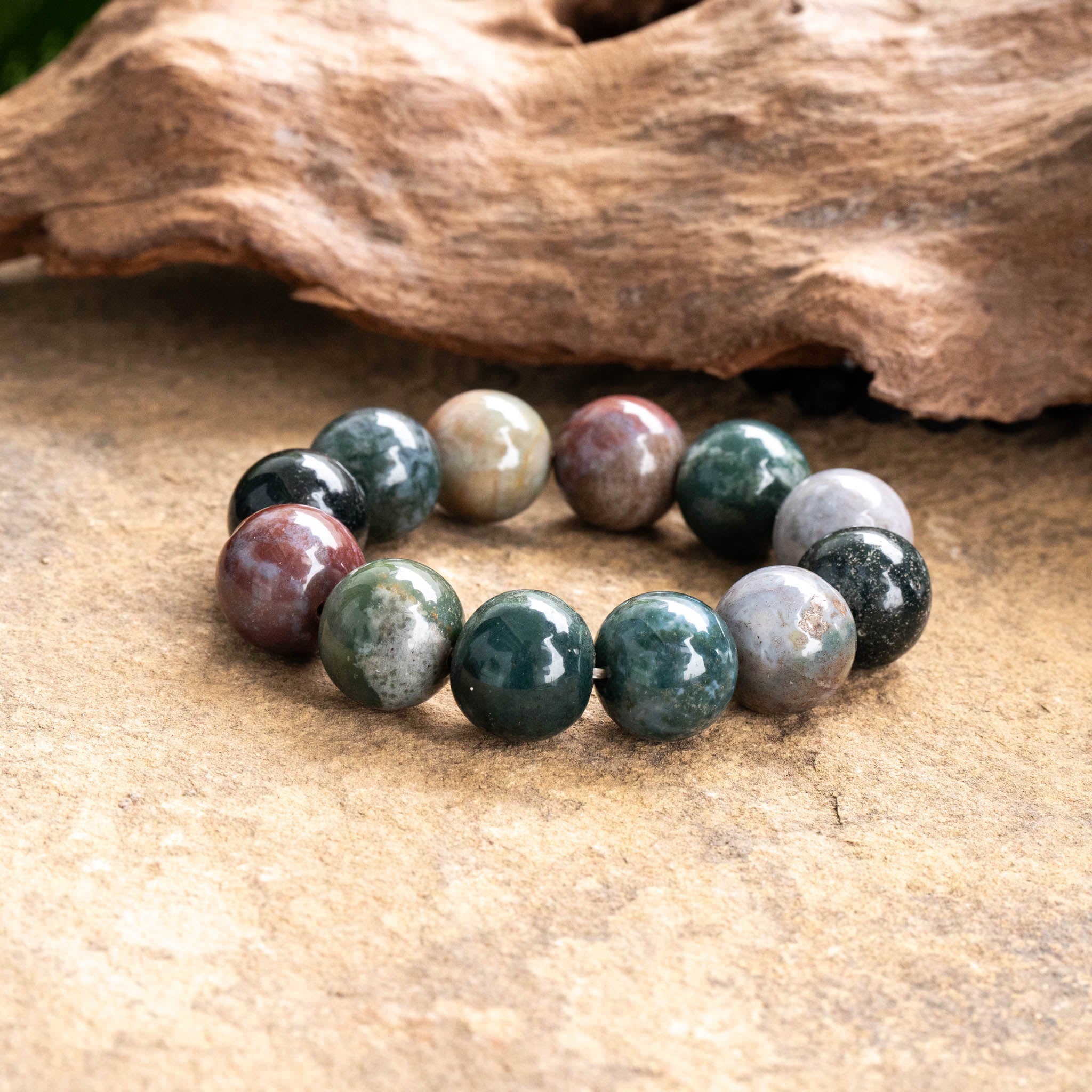 Agate bracelet with large round beads on flexible elastic cord, showcasing unique gemstone patterns.