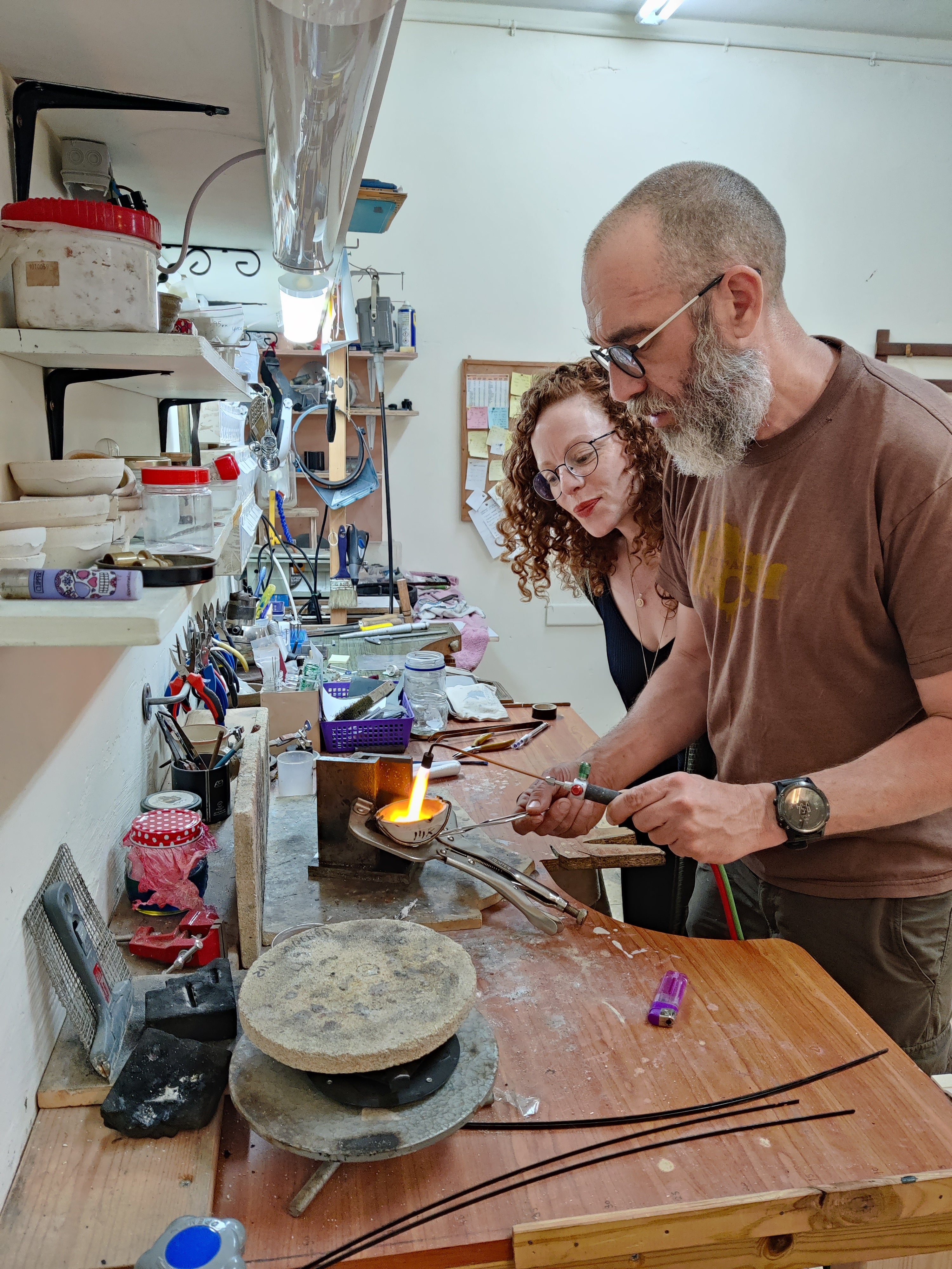 Jewelry workshop in Koh Chang Thailand – goldsmith guiding couple in creating wedding rings.