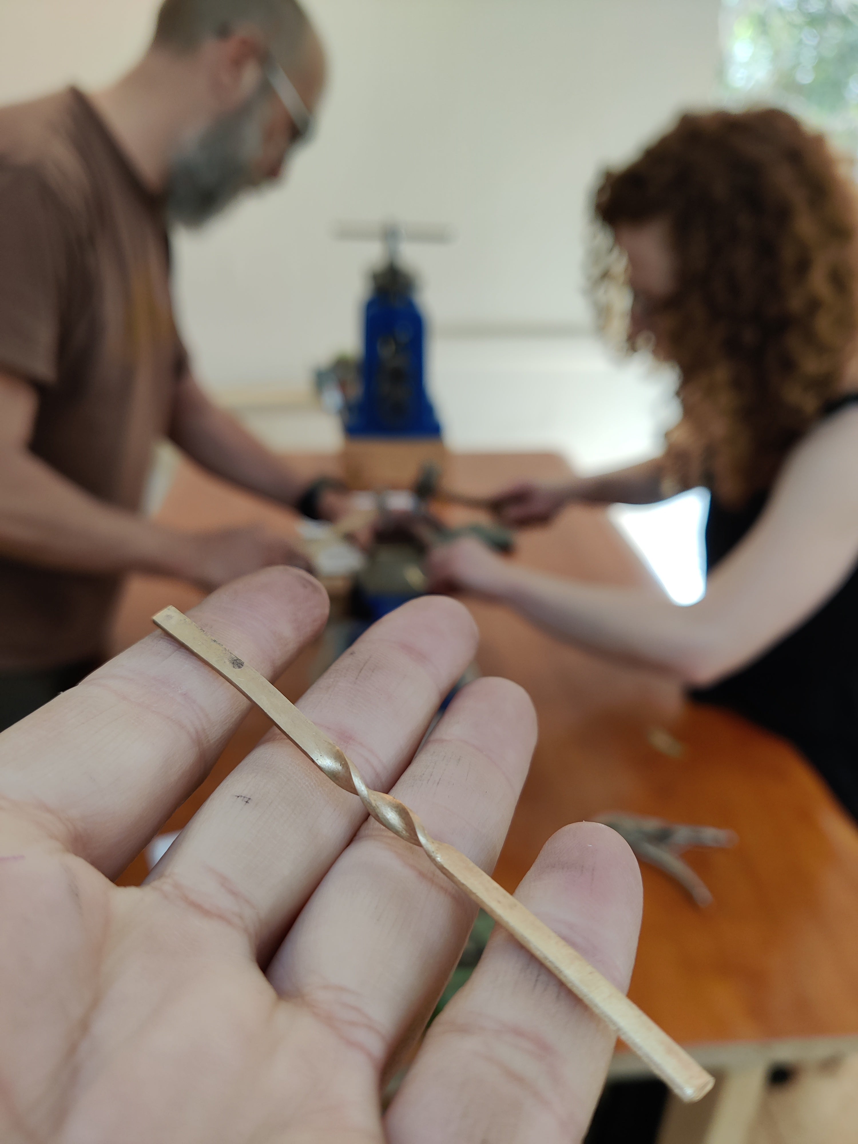 Shaping gold band by hand in wedding ring making workshop Koh Chang Thailand.