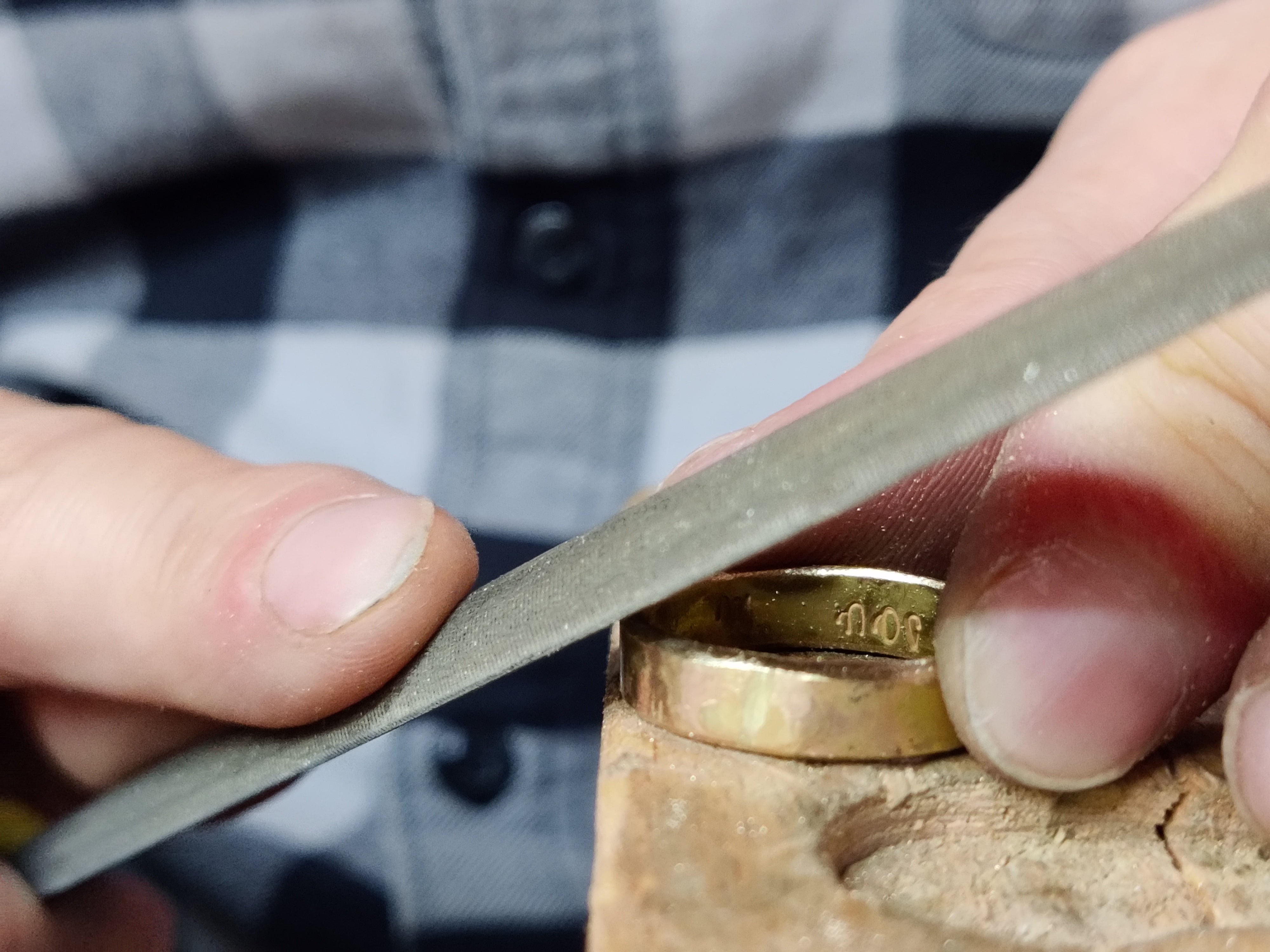 Polishing handmade wedding rings in Koh Chang goldsmithing workshop.