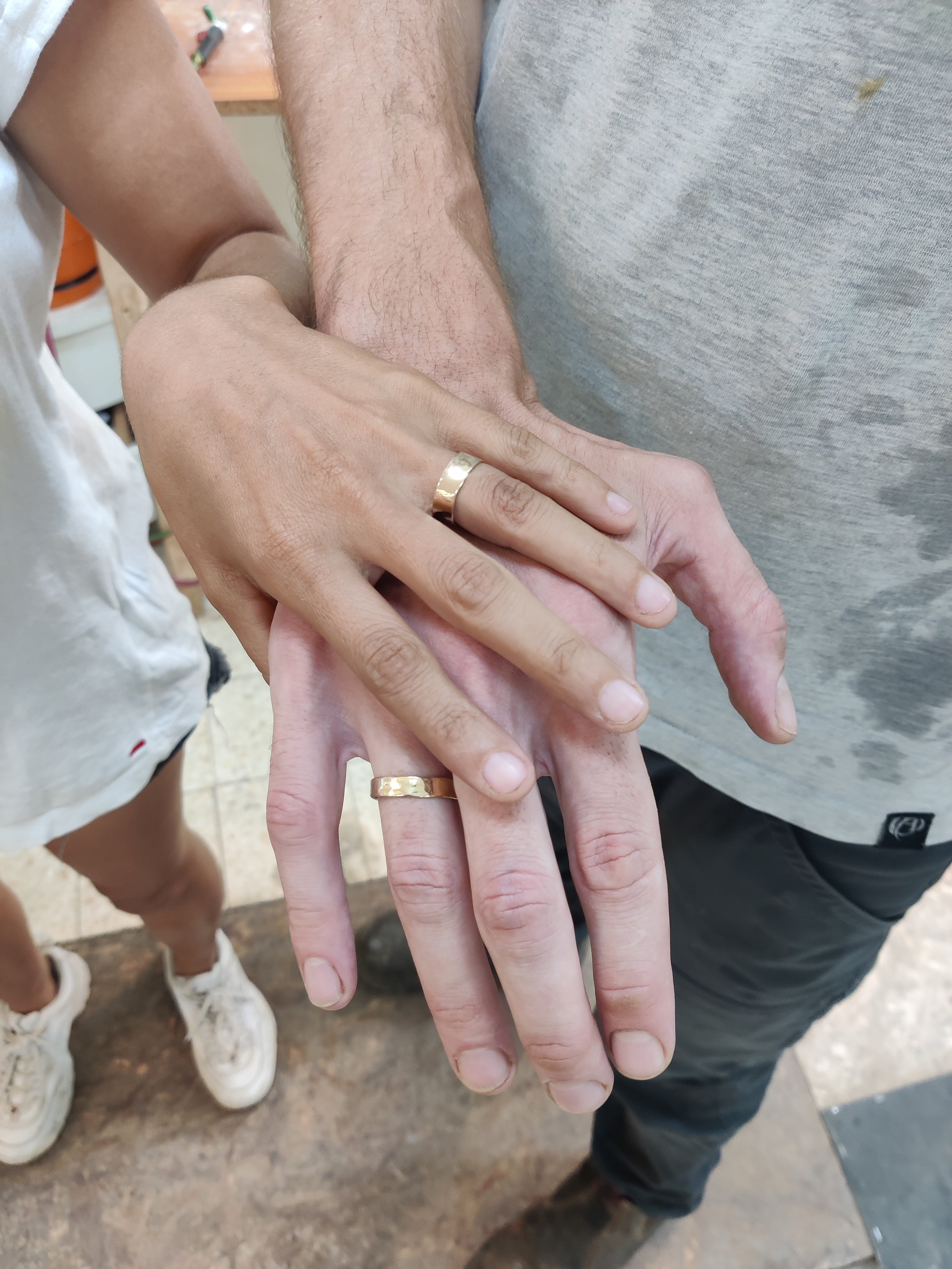 Couple showing their finished gold wedding rings made together in Koh Chang studio.