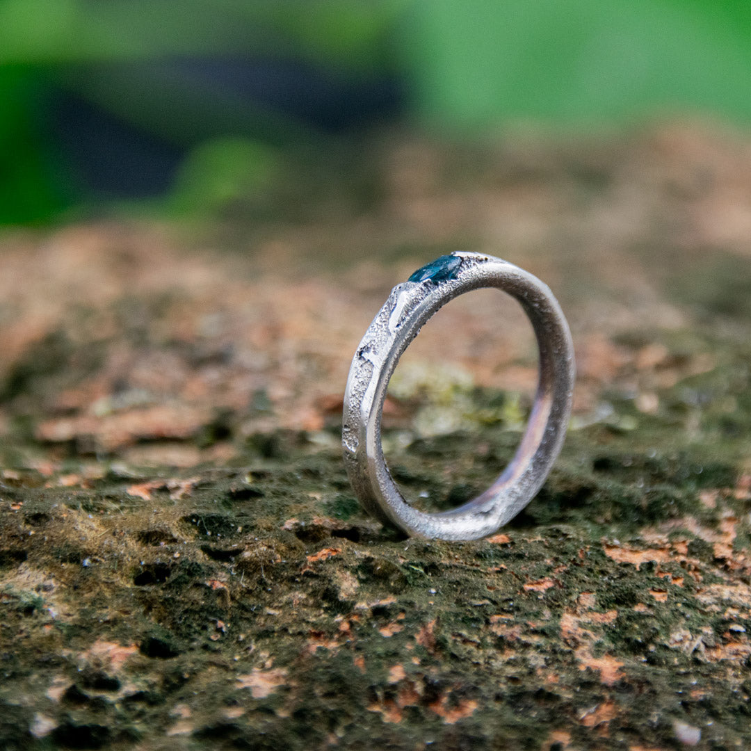 Blue Sky zirconia sand casting ring showcasing unique textures and organic shapes on a natural background.