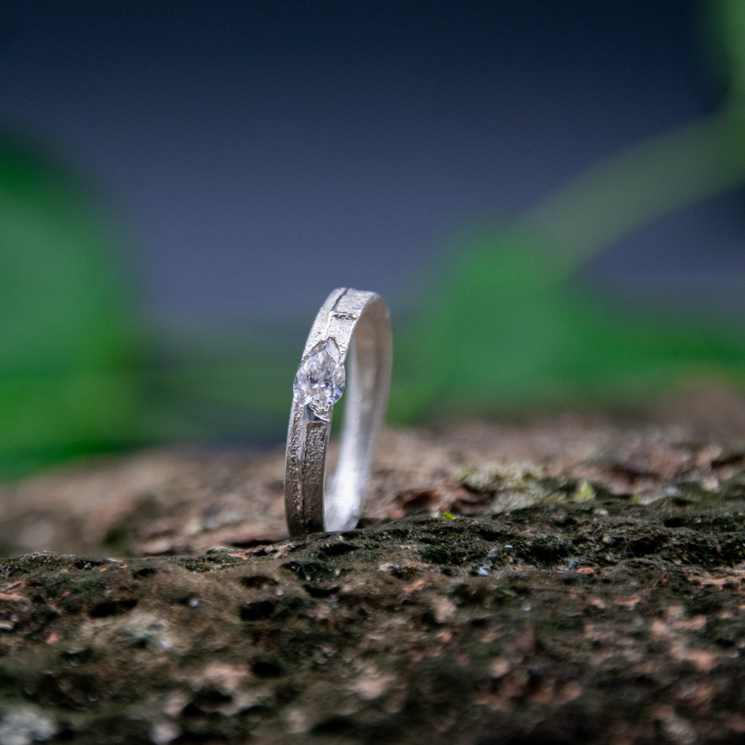 Elegant crystal zirconia sand casting ring showcasing unique textures and craftsmanship on a natural backdrop.