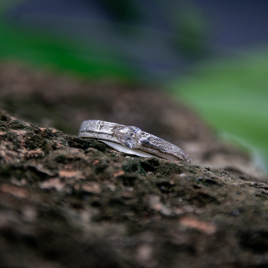 Unique crystal zirconia sand casting ring showcasing organic textures and artisanal craftsmanship against a natural backdrop.