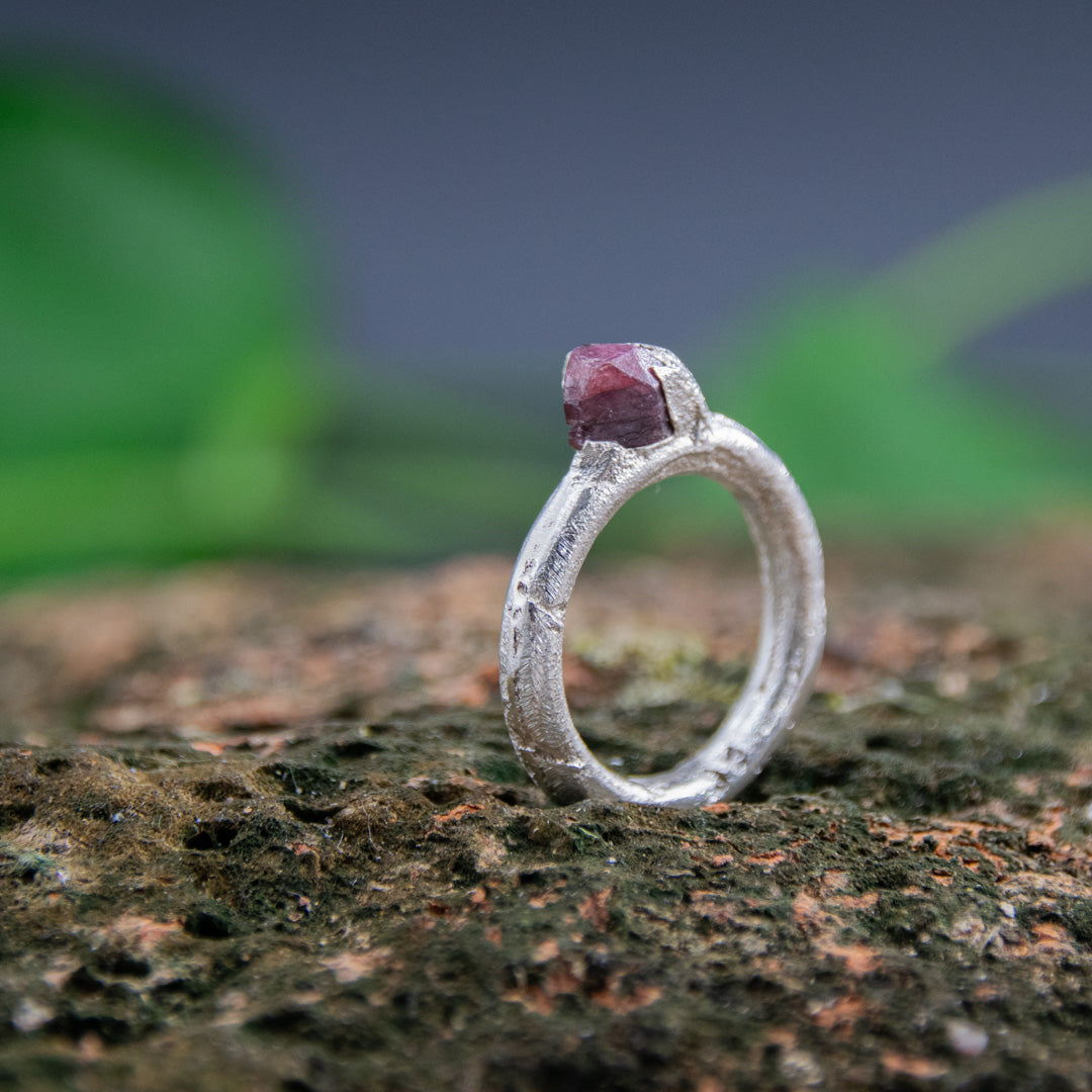 Unique raw ruby round ring with organic texture, crafted using sand casting technique.